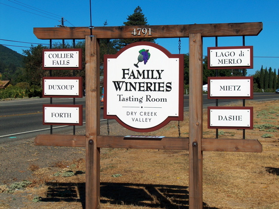Matted wood signs on natural redwood structure.  We mounted 

the winery names on the sides because the County gave us a strict height restriction. It is a unusual design idea but it allowed us to 

comply