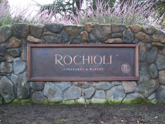 This sign has a patina copper background with 1/8" copper letters mounted to the face.  The sign was then 

framed in redwood and mounted into the rock wall