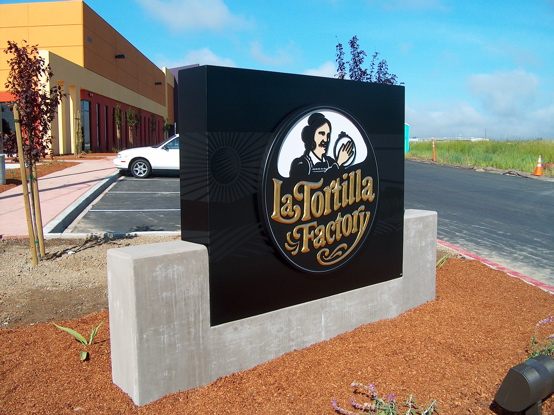Fabricated aluminum box with flat black vinyl graphics under 

a 3d carved logo icon painted with enamels and 23k gold leaf 