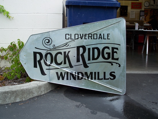 Vinyl 

on a provided windmill tail.  An old fashioned design created in house