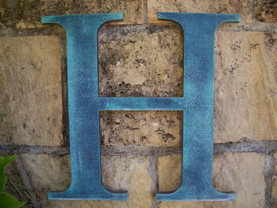 Faux finished aluminum letter.  Painted 

to look like heavily patina-ed copper 