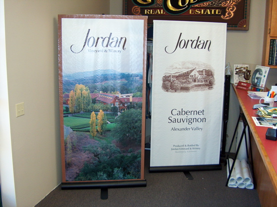 Jordan digital banners mounted on custom display 

racks.  The racks work in a manner similar to a window shade.  The banner unrolls from the bottom and hooks to the top