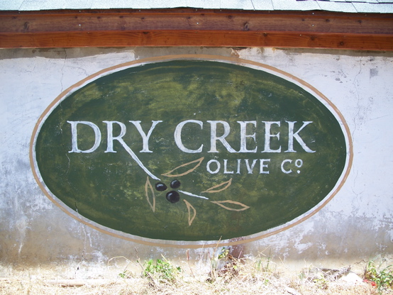 Dry Creek 

Olive hand lettered and distressed to look old.  The white washed surface was left untouched