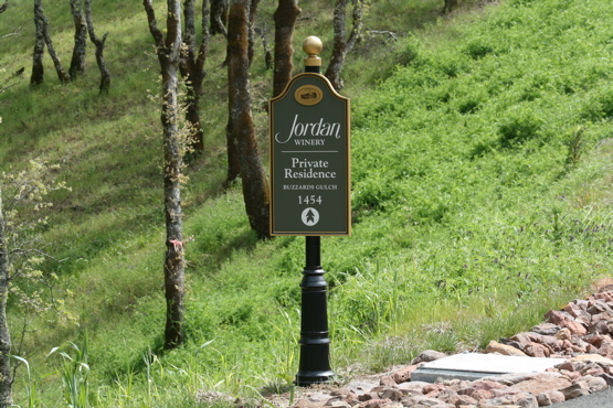 Jordan Winery aluminum & urathane directional all painted with an automotive finish 

on custom base with finial.  All lettering is white reflective