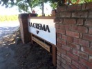 Redwood 6x6 post hold a 2" thick laminated cedar panel.. The aluminum face is brushed with 1/2" plex letters and symbol 